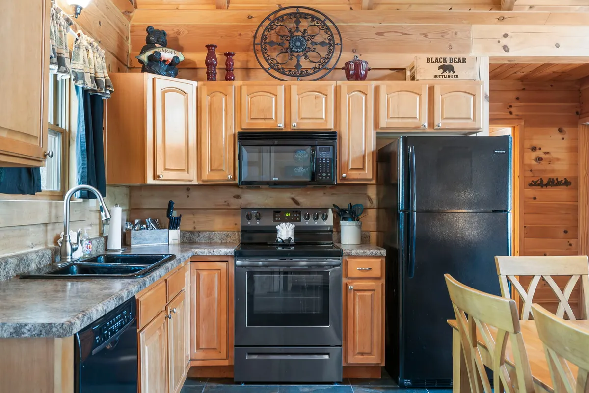 A stylish kitchen with wooden cabinetry and stainless steel appliances, complemented by a cozy dining table and decorative touches. The space feels both functional and homely, ideal for preparing family meals and entertaining guests.